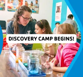 Image of camp counselor with two kids at a table and mason jars filled with colorful liquid. Text reads Discovery Camp Begins!