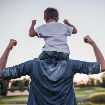 father with son on his shoulders