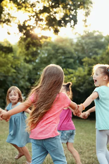 kids playing and holding hands in a circle