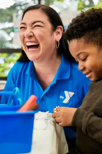 Happy YMCA employee with happy child