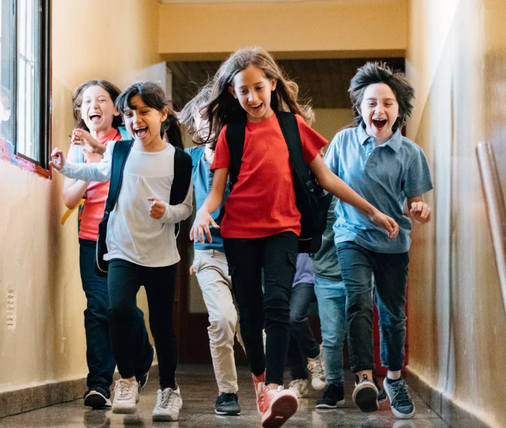 happy school children running down the hall