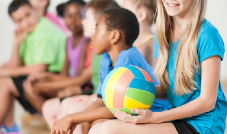 Kids on a bench at a volleyball camp