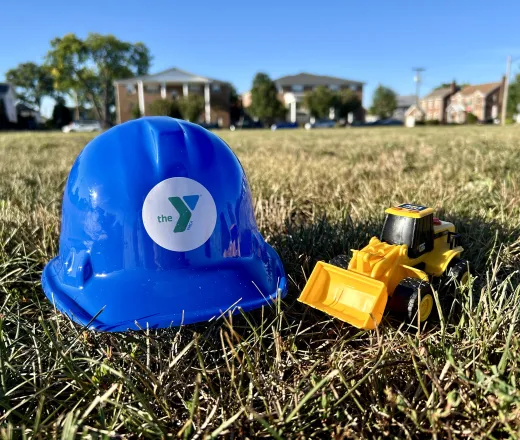 Children's hardhat with toy bulldozer.