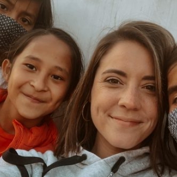 Missionary woman with children smiling