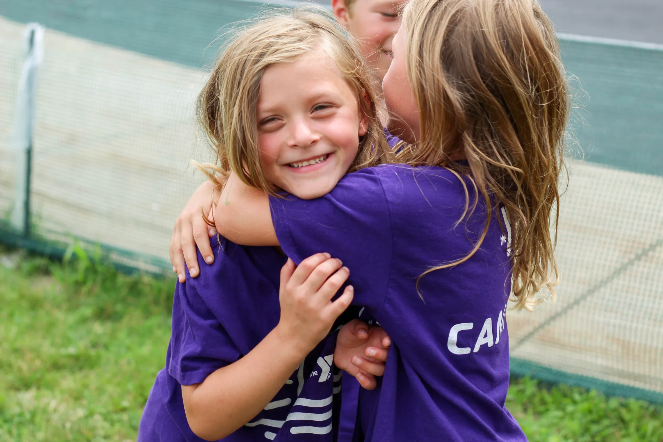 two girls hugging at camp