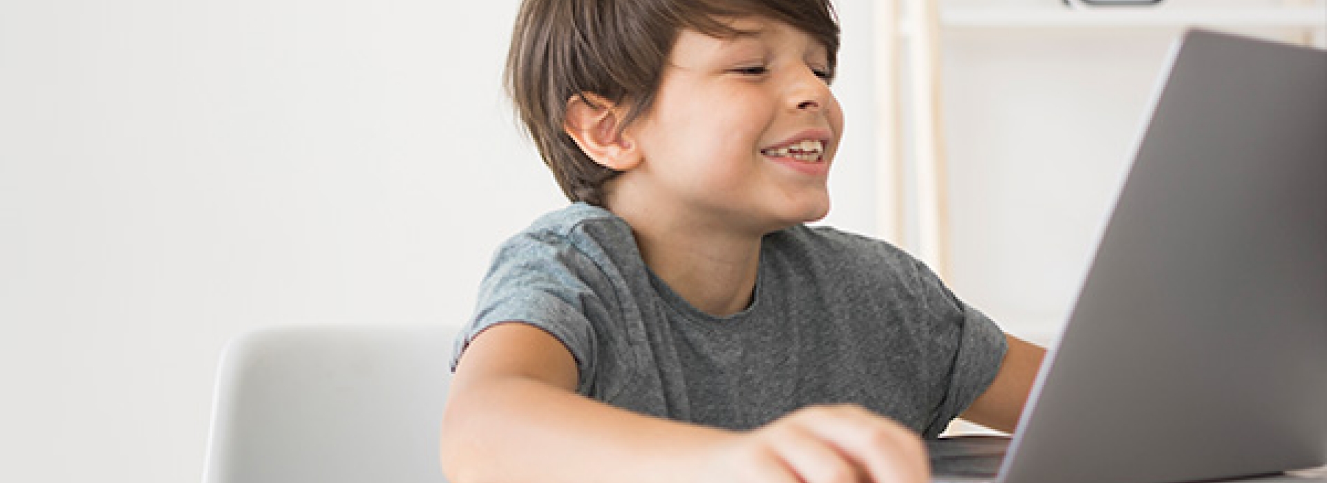 Young teen watching computer screen