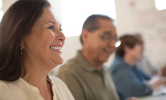 A woman smiles in a group setting
