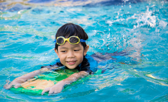 A child swimming with a kickboard