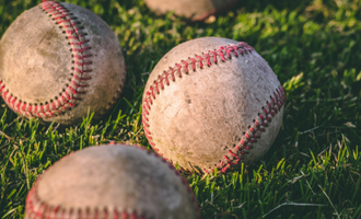 baseballs in grass