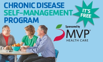 Group of People sitting at a table talking and MVP sponsor logo