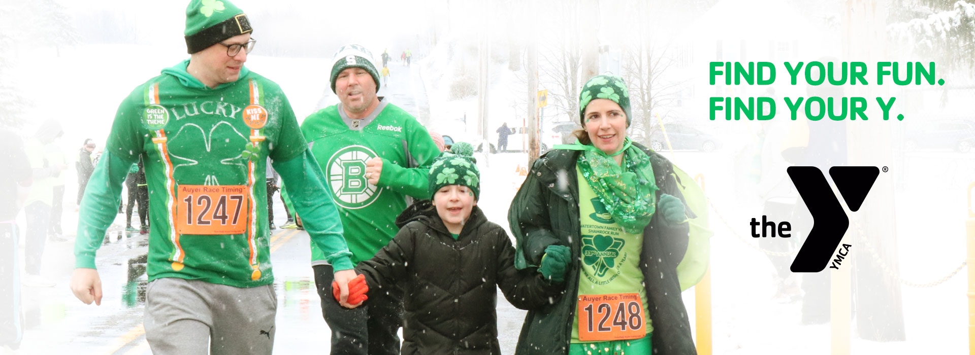 Family in green crossing finish line at 2022 Shamrock Run