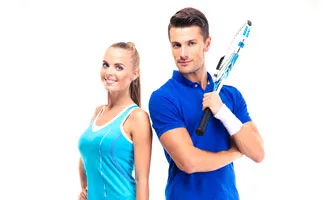 Couple holding tennis racquets