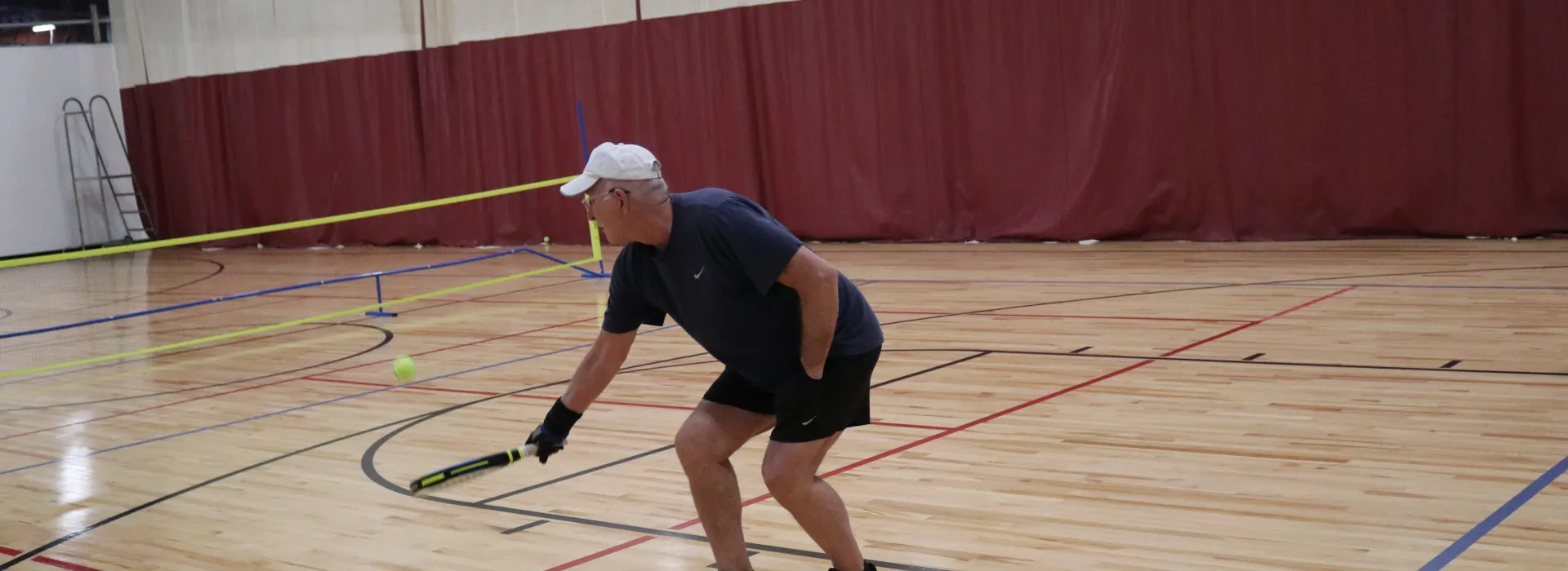 an adult playing pop tennis