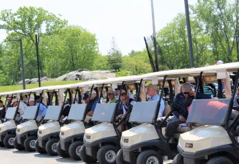 Golfers and carts lined up for the 2023 WSYMCA Annual Golf Tournament