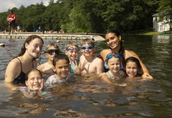 group of campers and swim instructors in the lake