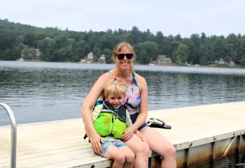 mother and son sitting on dock at Camp Frank A. Day during WSYMCA Family Camp weekend