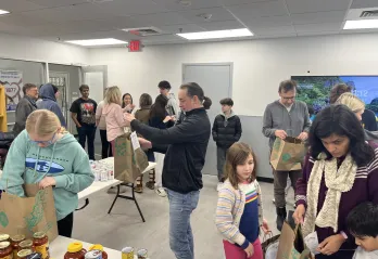 group of volunteers packing meal kits at the wells ave ymca