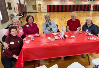 6 people sitting around a table at the Church St Y