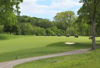 Golf carts driving on Charles River Country Club