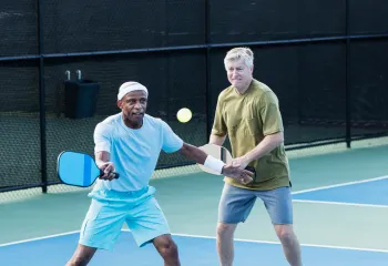 2 men playing doubles pickleball