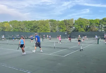 YMCA members playing pickleball outside