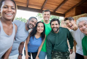 group of adults outside smiling