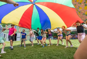 Campers at Camp Chickami playing with the parachute game