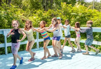 Camp Chickami campers having fun dancing in a line together