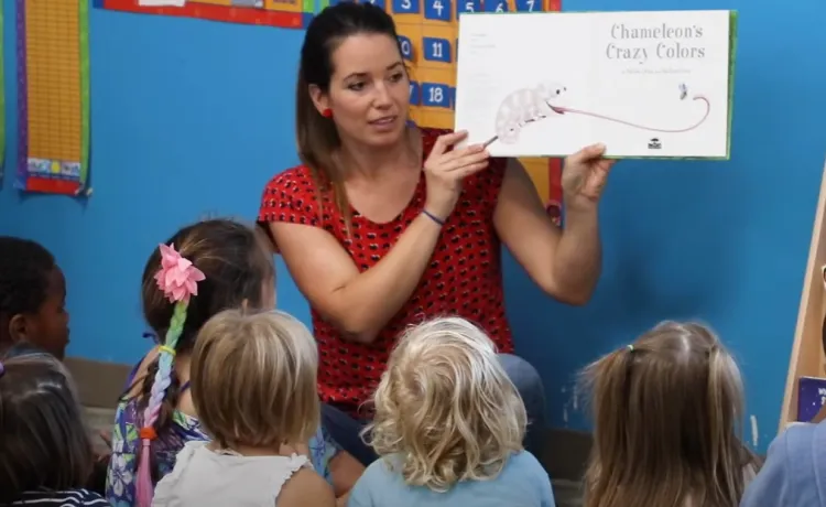 A preschool teacher reads a story to a group of children