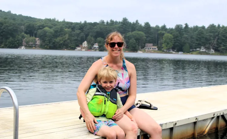 mother and son sitting on dock at Camp Frank A. Day during WSYMCA Family Camp weekend
