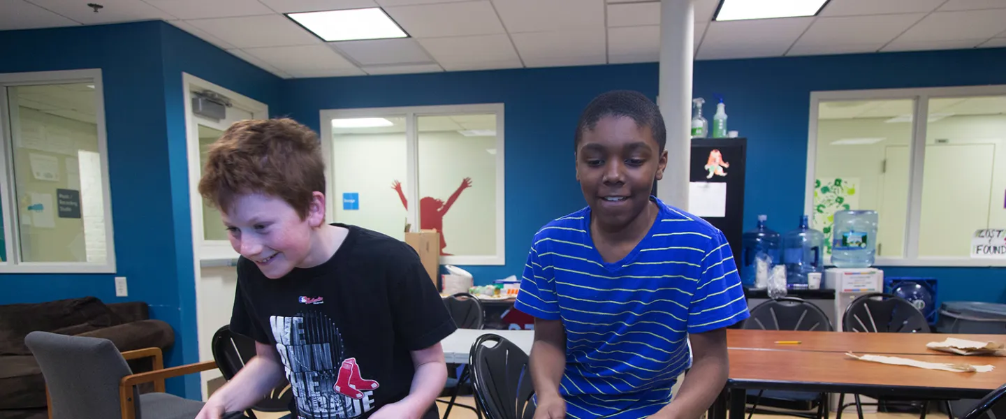 Two teenage boys play foosball in the YMCA Teen Center