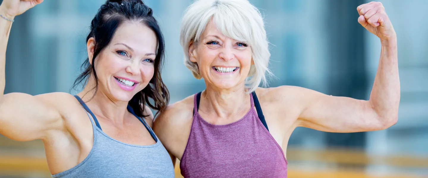 2 Older Adults in workout gear smiling