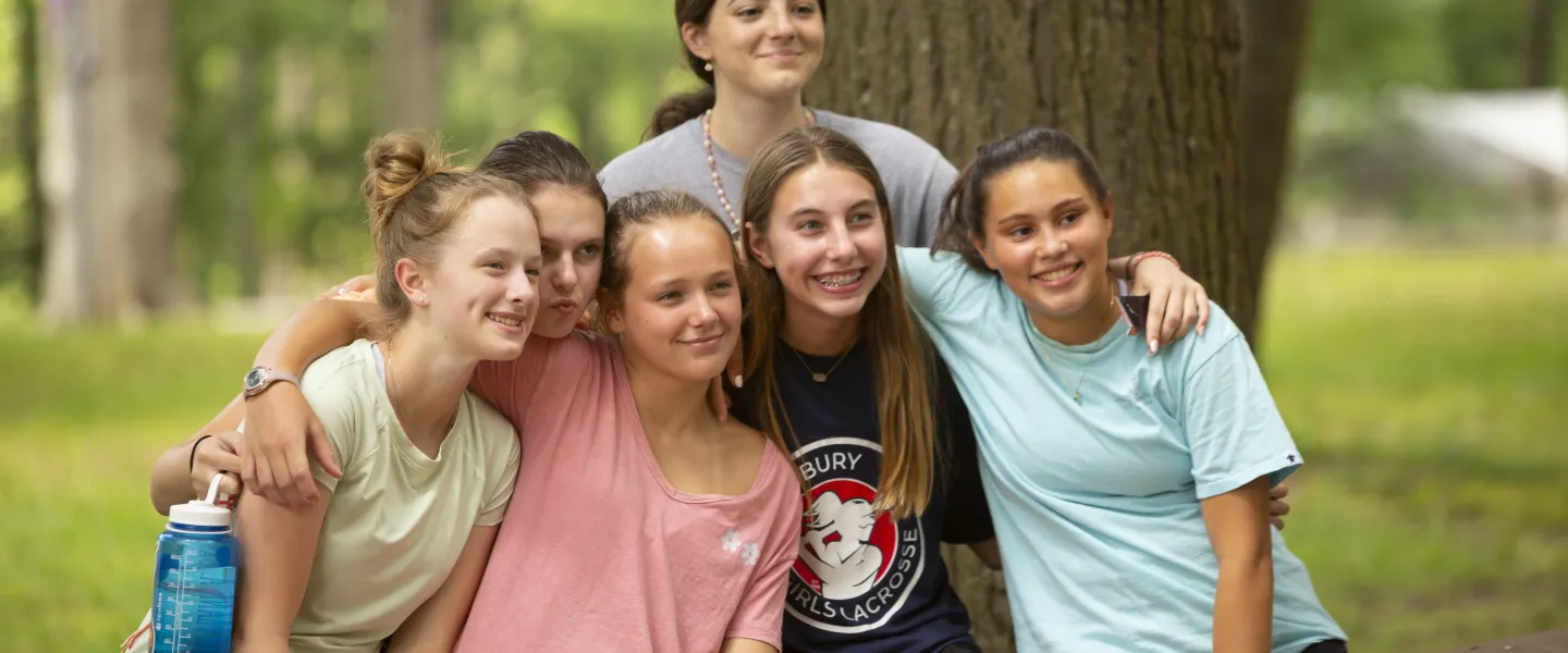 Group of female campers hugging