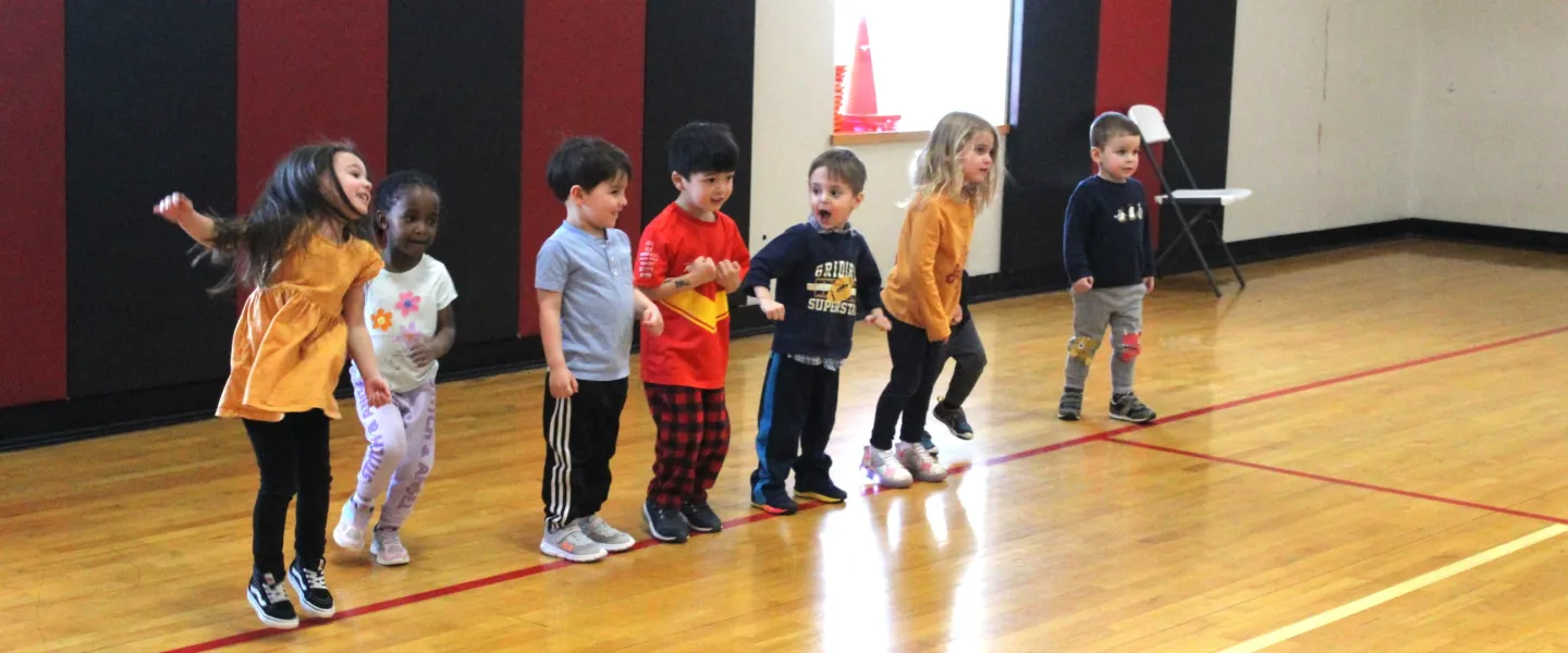 preschool students lined up to run in the gym