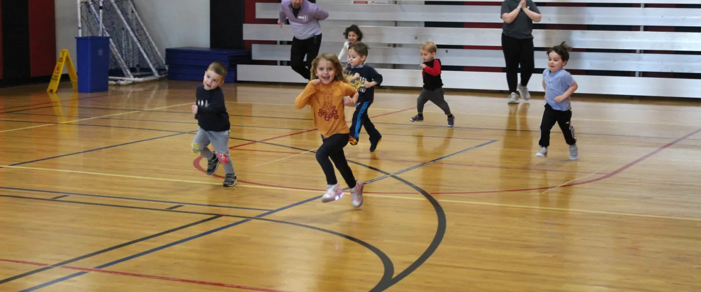 preschoolers running in the gym