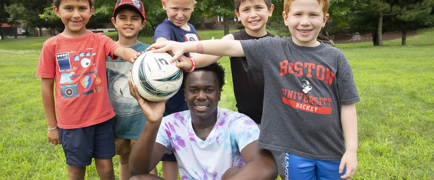 A consular and his 5 kids taking a break mid soccer game. 