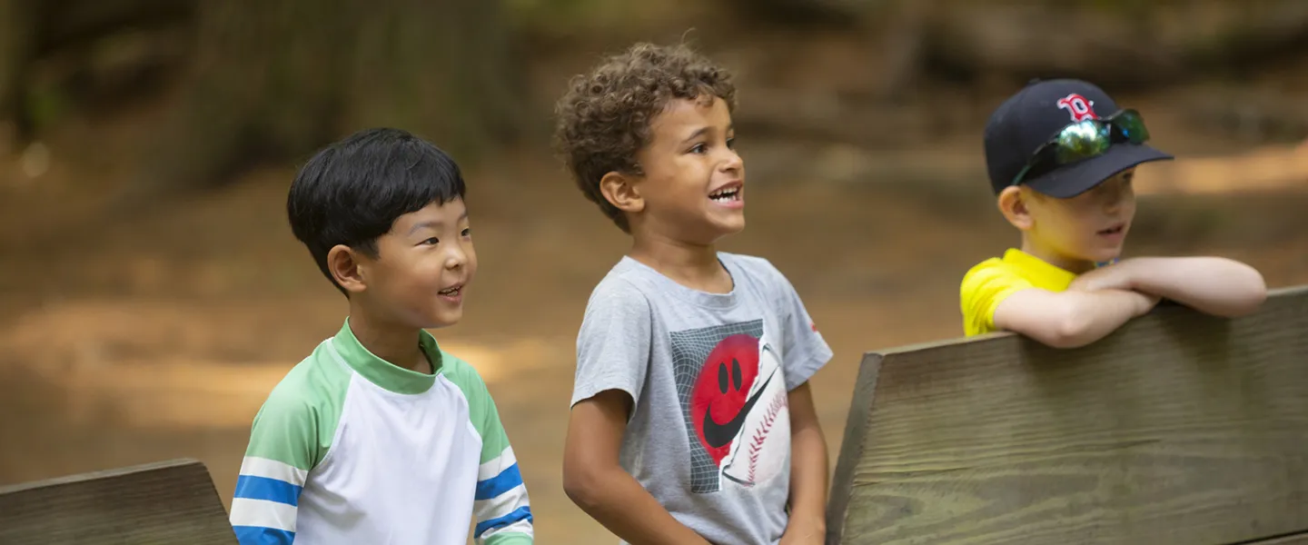 Three campers anxiously waiting outside the gaga ball pit to play.