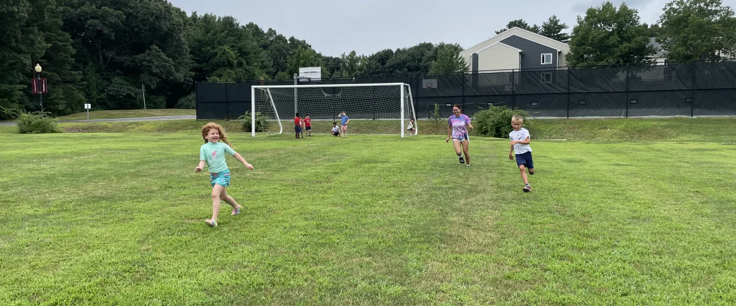 Young campers run around the Wells soccer field.