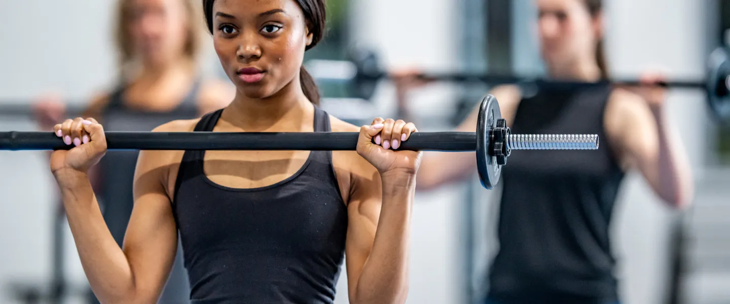 Teens in group class with barbells