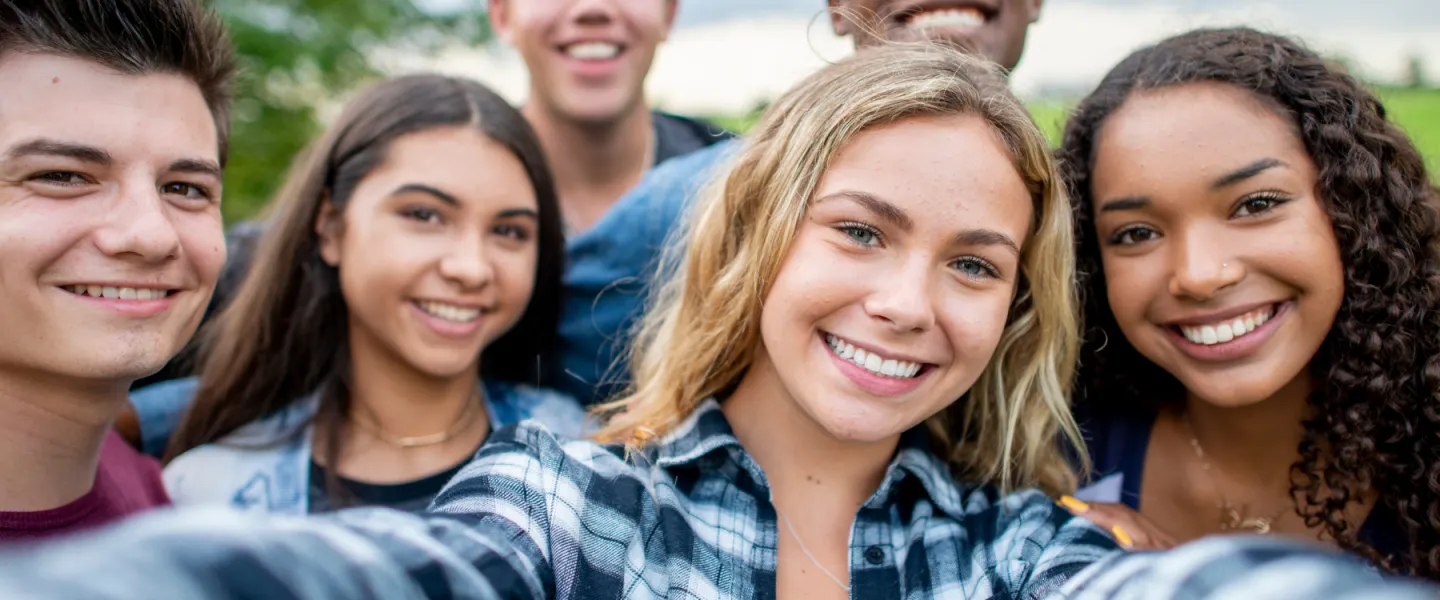 Group of teens taking selfie and smiling