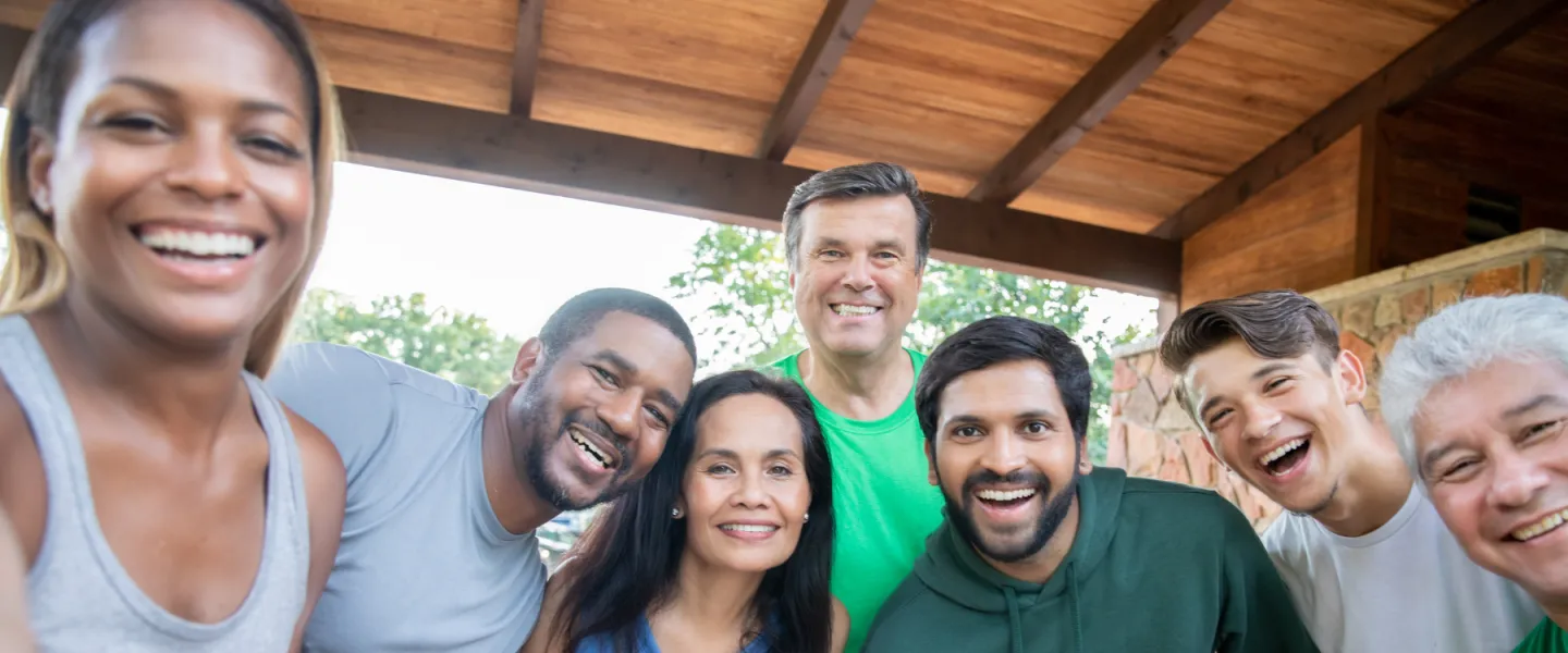 group of adults outside smiling