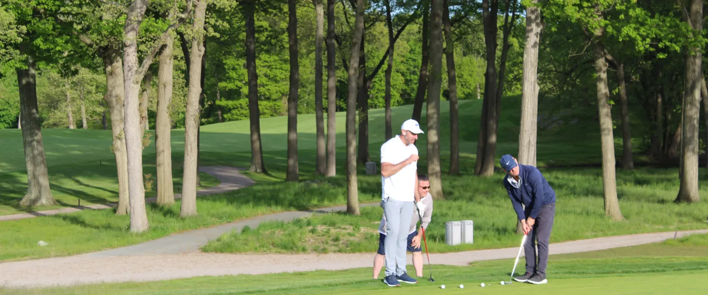 team cheering during golf putting