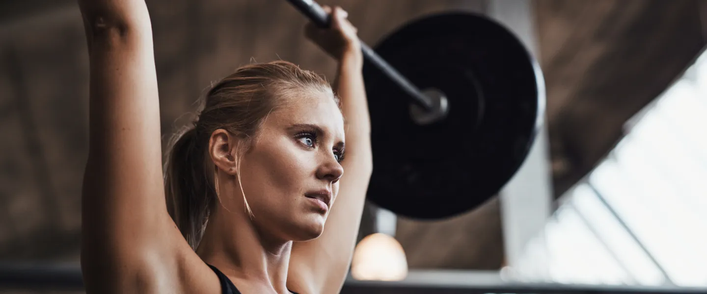Learn To Lift at the Y, a woman lifting a weight bar