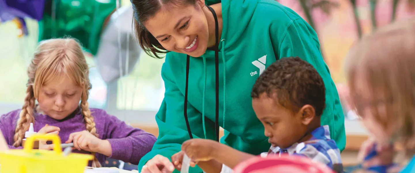 Y staff helping children with crafts