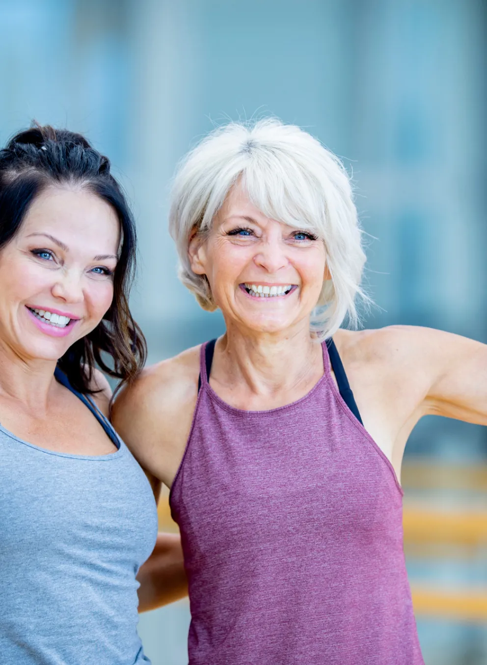 2 Older Adults in workout gear smiling