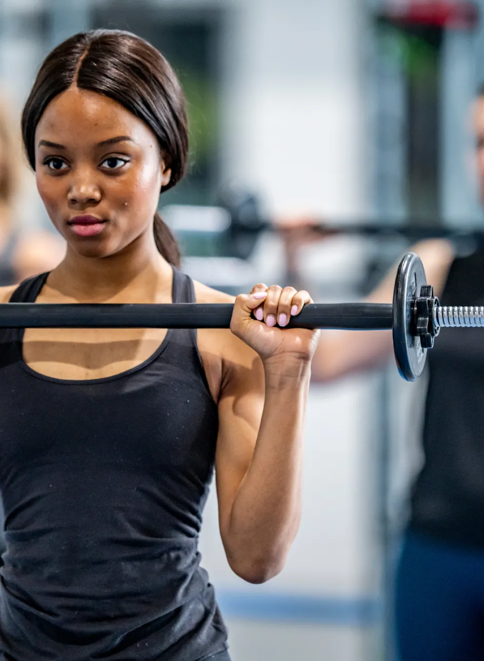 Teens in group class with barbells