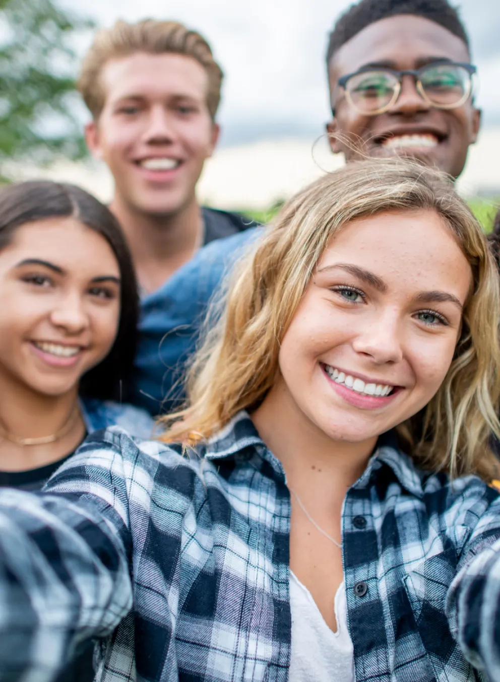 Group of teens taking selfie and smiling