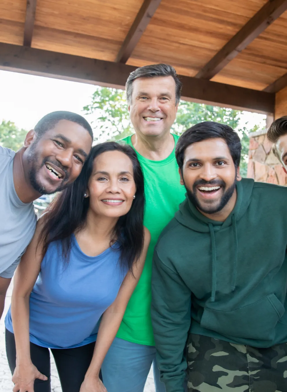 group of adults outside smiling