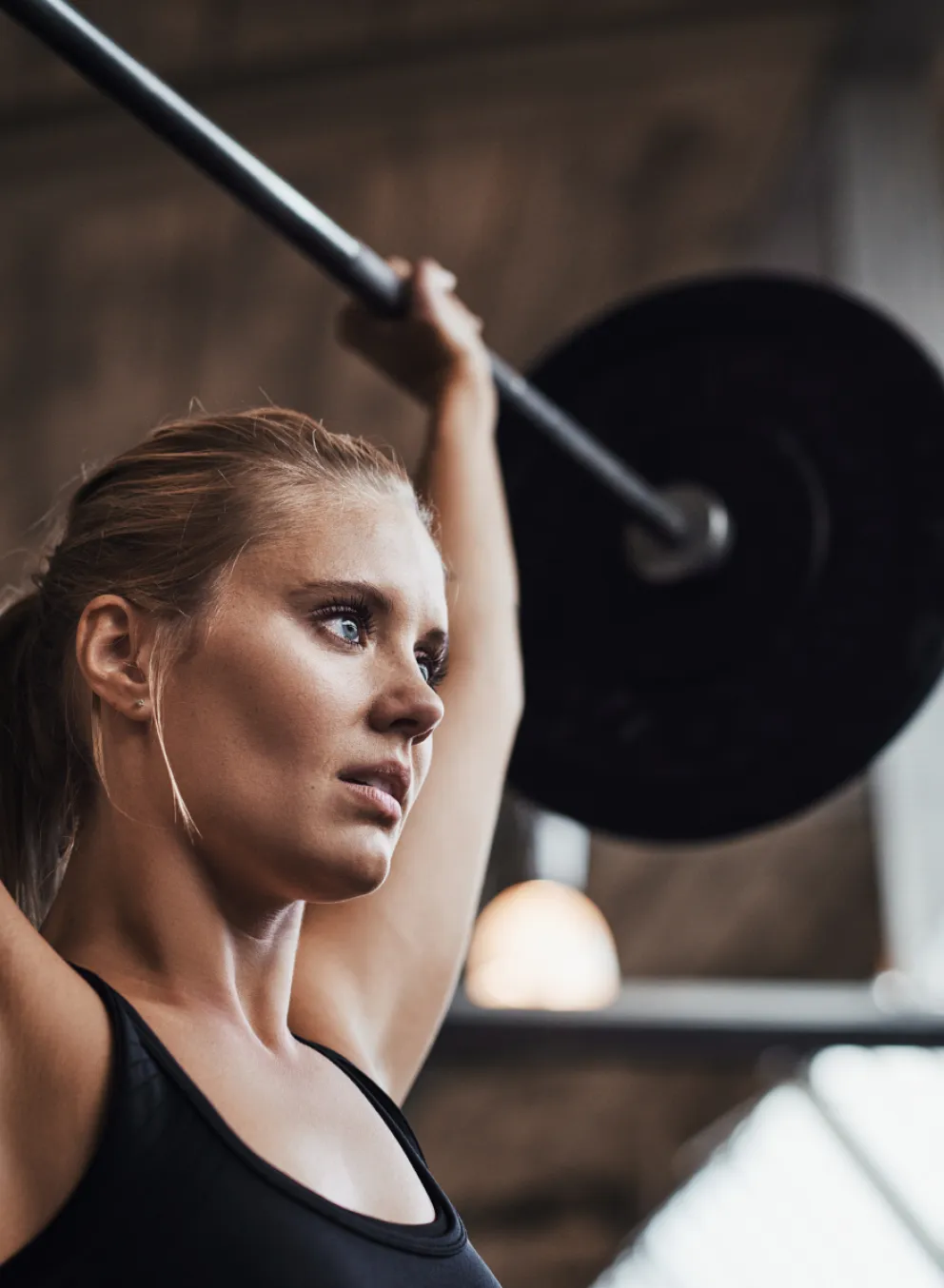 Learn To Lift at the Y, a woman lifting a weight bar