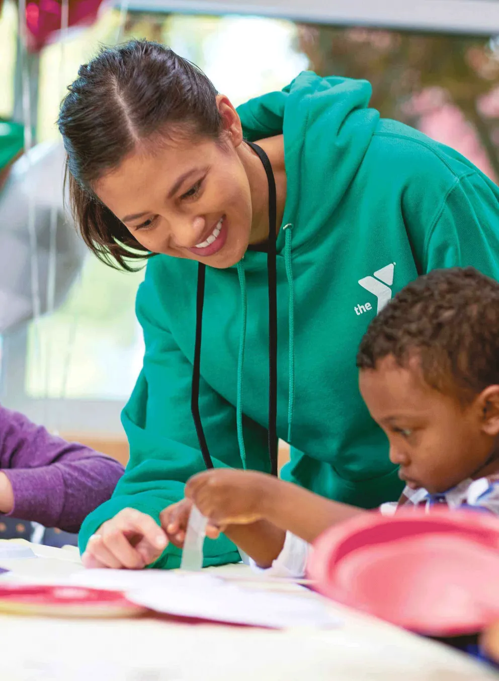 Y staff helping children with crafts